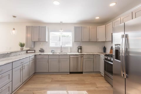 A large kitchen can be found in the heart of the home. Enjoy a gas range, oven, full size refrigerator, microwave, dishwasher, and all the basics you need for cooking. We also provide dining ware for kids and a coffee pot.