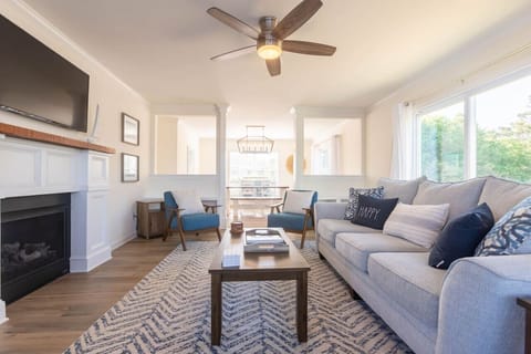 The living room offers comfortable seating, a 55" smart TV for all your streaming needs, access to the wrap-around deck and is just off the dining room.