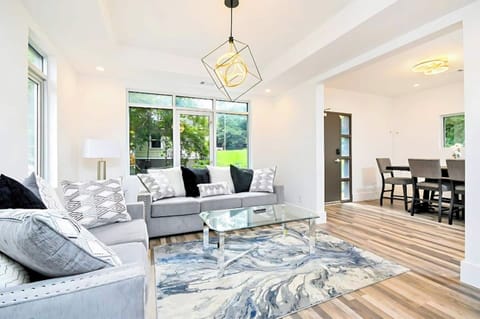 Large windows and chic decor create a bright, welcoming living space.