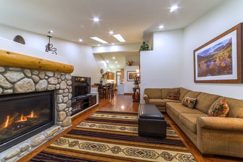 Gorgeous open living area with warm hardwood flooring throughout