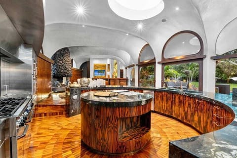 An executive chef kitchen, equipped with top-of-the-line appliances, including a sleek espresso machine—ideal for culinary enthusiasts and coffee lovers who appreciate the finest details in both cooking and brewing!