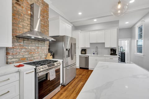 This stunning, fully equipped kitchen features modern appliances, a large island, and beautiful finishes—perfect for gathering with friends and family.