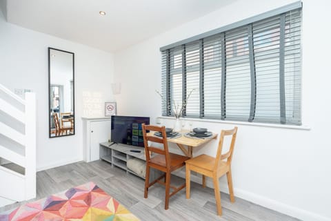 Bright, colourful and cosy living room with smart TV.