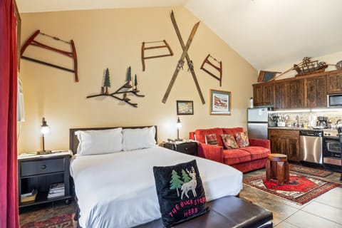 Bright and comfortable studio featuring a queen bed, seating area, and open layout—perfect for relaxing after a day of adventure.