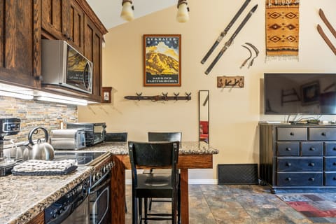 Kitchen and dining setup with bar seating—perfect for meals, snacks, or planning your day's adventures.