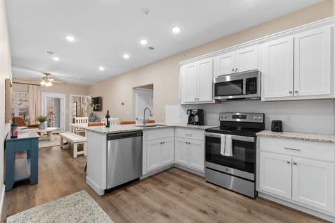 Modern kitchen with stainless steel appliances, granite counters, and style.