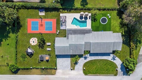  A bird's-eye view of paradise! From the expansive driveway to the backyard’s incredible amenities — sauna, hot tub, fire pit, sport court, pool, trampoline, mini-golf, and hammocks — this is the ultimate getaway.