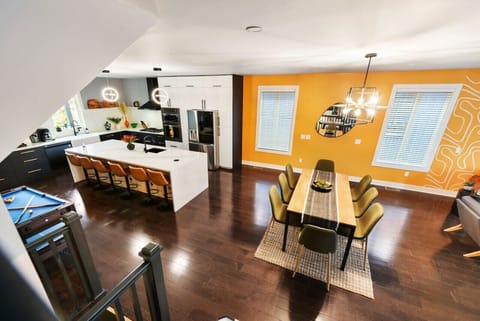 Kitchen for meals, big table for hangs. Plus, a pool table!