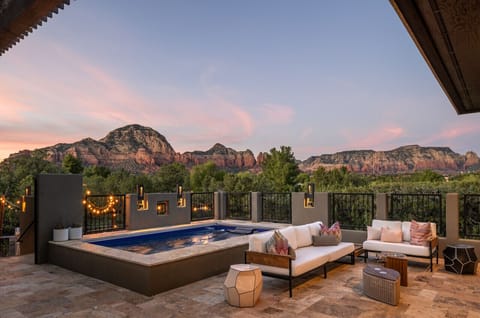 Views from private courtyard featuring endless pool, fireplace, and patio seating.