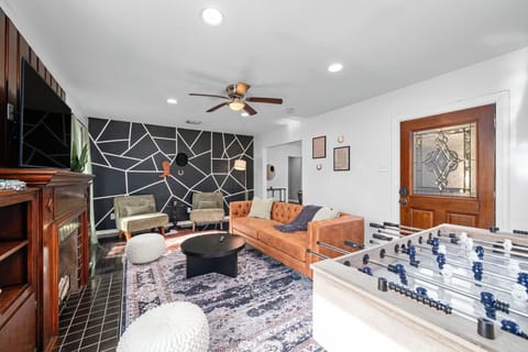 Living room with plush couch, foosball. and ceiling fan