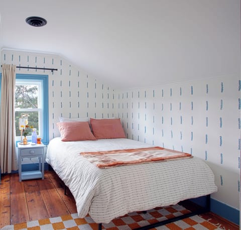 Blackout curtains, desk, and a full-size bed