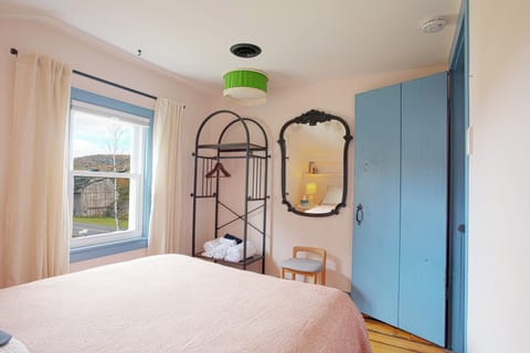 Barn-view bedroom features a blackout pulldown shade, wardrobe and full-size bed