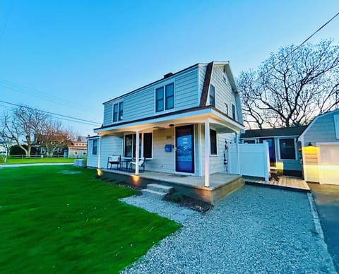 Front of house, garage and extra large outdoor shower.