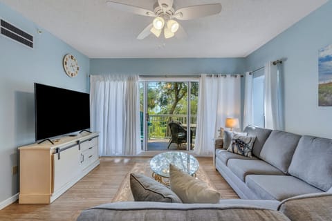 Living room with smart TV and ocean view balcony access