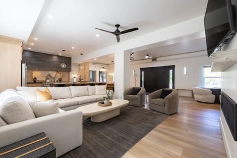 Open concept living area with gas fireplace, smart TV, and chef's kitchen
