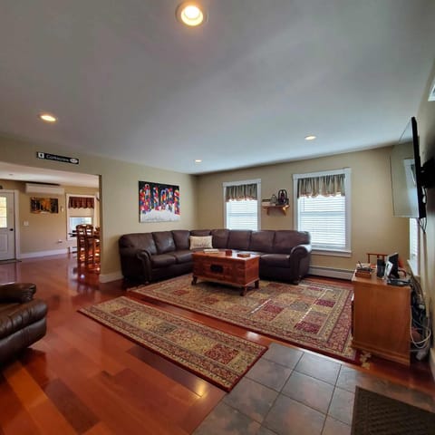 Living room with large tv and seating area.