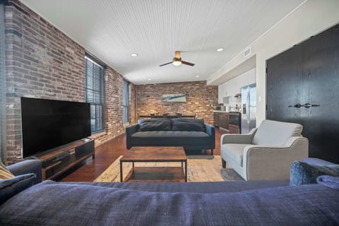 Living Room: Enjoy this comfortable living space with large windows, a flat-screen TV, and plush seating perfect for unwinding after a day of exploring.
