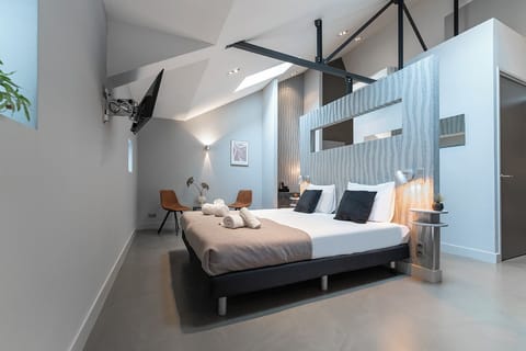 The same bedroom from a different angle, showcasing a harmonious blend of contemporary design and cozy textiles, enhanced by natural light.