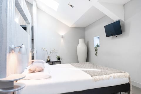 Light-filled bedroom with soft tones and comfortable bedding. Perfect for couples.