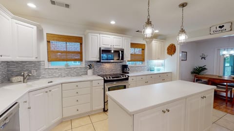 Kitchen with stove, refrigerator, dishwasher, and microwave. 