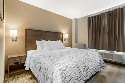 Unwind in a crisp, cozy bed with soft lighting.