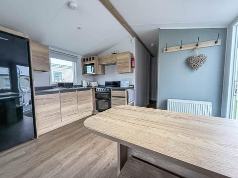 Modern kitchen with sleek appliances and cozy dining nook
