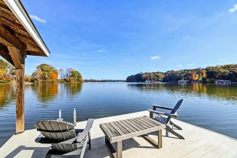 Private dock with Adirondack chairs and table, offering a tranquil spot to relax by the lake