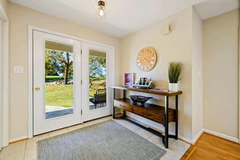 Bright and welcoming entryway with a view, featuring a stylish console table and decor