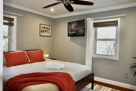Sleep like royalty. This bright and airy master suite features a plush bed, premium linens, and a wall-mounted TV for private viewing.