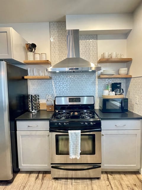 Gas cooktop, stainless appliances, dishwasher; plenty of cookware, dishes, utensils, and spices; coffee and tea!