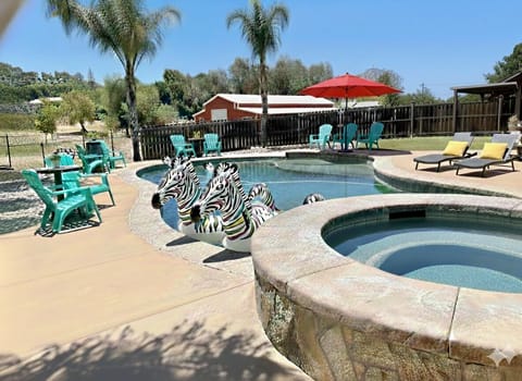 Heated pool overlooking peaceful ranch space designed for multi-family stays.