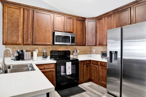 Fully equipped kitchen with a sleek range, microwave, and plenty of counter space to make meal prep a breeze