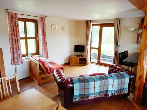 Living room with sofa, armchair, tv, dining table