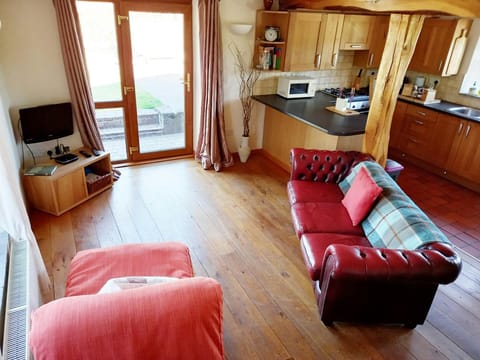 Living area with sofas, armchair, tv