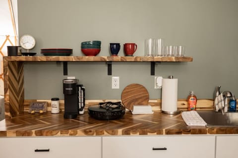 Step outside to your private outdoor oasis featuring a cozy deck, grill, and shaded seating area. Relax by the fire pit with free firewood provided. This peaceful retreat offers the perfect blend of comfort and adventure.