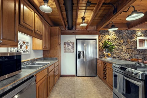 The sophisticated kitchen offers ample space & all the comforts of home