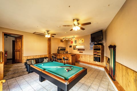 Game room with bar, convertible pool table, TV, and stereo system