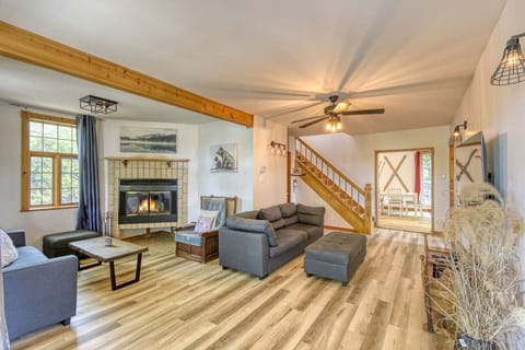 Spacious and bright living area featuring a ceiling fan—combining comfort and airy openness.