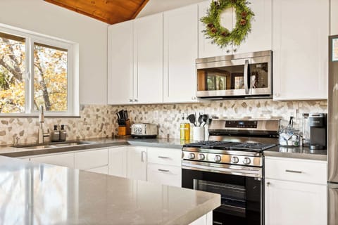 The chic, updated kitchen offers ample space & stainless steel appliances.