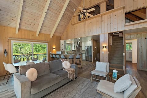 Open-concept design enhanced by dramatic peak ceiling.