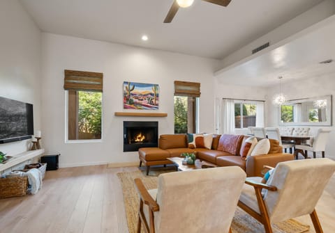 Spacious and airy living space features fireplace, smart TV & sound system