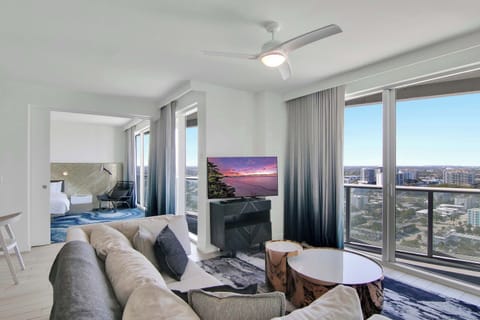 Floor-to-ceiling sliding glass doors in the living area