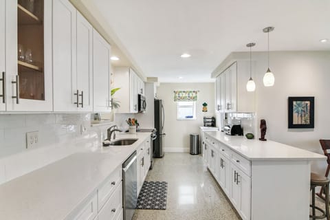 The bright, cheerful kitchen offers ample space & all the comforts of home