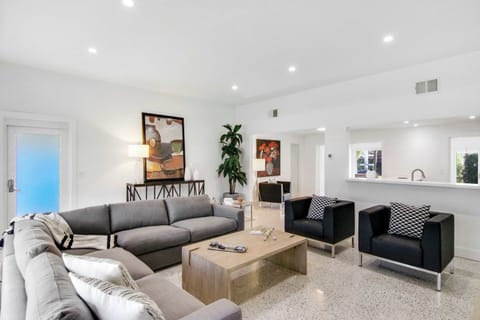 Modern spacious living area with TV and wide glass windows