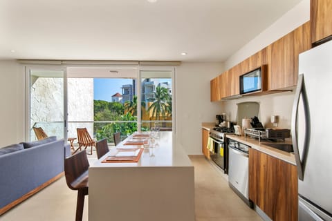 Fully equipped kitchen & dining area with balcony access.