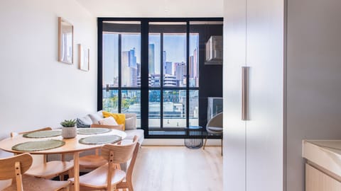 Bright open-plan living and dining area with balcony access