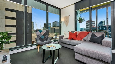 Bright living area with floor-to-ceiling windows and city views