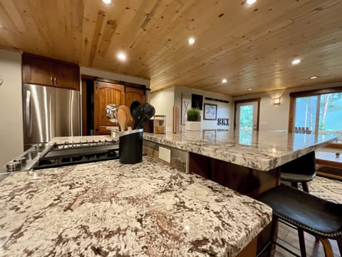 Beautiful kitchen with large granite bar and bar sitting.