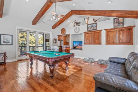 Entertainment Hub: Features a full-sized pool table, bar area, and multiple living spaces for relaxation and fun.