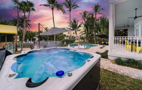 Private hot tub and covered patio for outdoor dining and relaxation. Enjoy Florida’s warm evenings in style. #HotTubRetreat #LuxuryRental #FortLauderdaleVacation